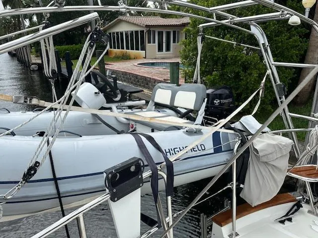 Last Love Yacht Photos Pics Inflatable boat on Passport 545 Vista yacht, docked near waterfront home, 2014 model.