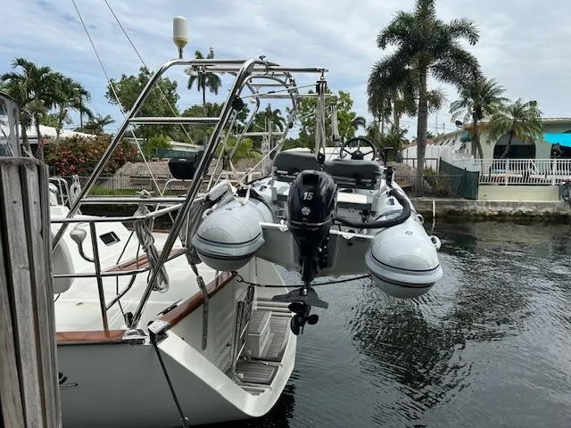 Last Love Yacht Photos Pics Sailboat docked with dinghy attached, Passport 545 Vista, 2014 model, tropical setting.