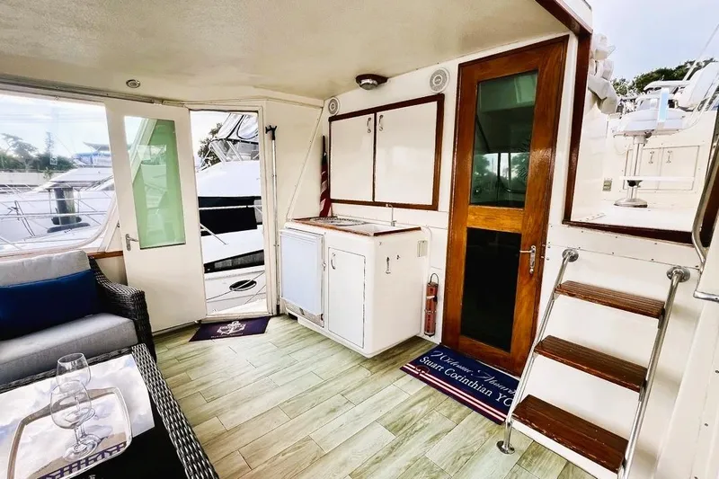 Shangri La Yacht Photos Pics Interior of 1988 Hatteras 43 Motor Yacht with seating, cabinetry, and wooden accents.