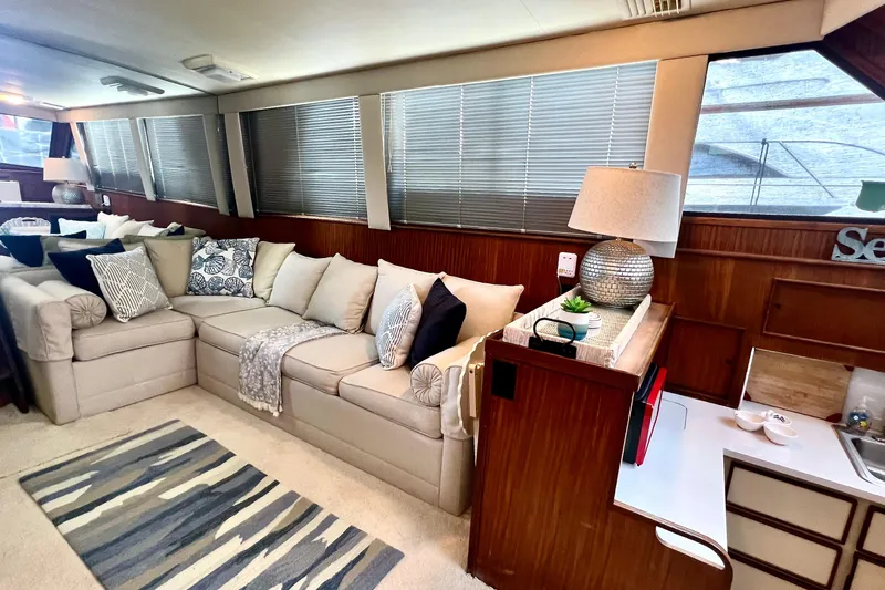 Shangri La Yacht Photos Pics Luxurious interior of 1988 Hatteras 43 Motor Yacht with cozy seating and elegant decor.