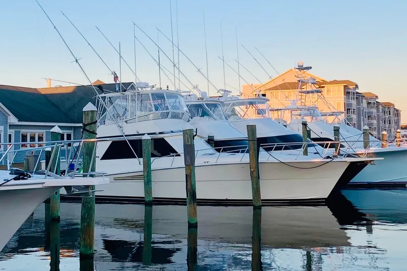  Yacht Photos Pics 1989 Viking 48 yacht docked at marina, surrounded by other boats, under clear sky.