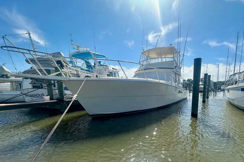 Yacht Photos Pics 1989 Viking 48 yacht docked in sunny marina, clear blue sky above.