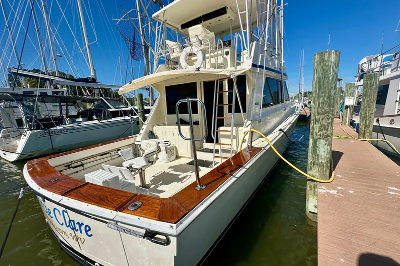  Yacht Photos Pics 1989 Viking 48 yacht docked at marina, featuring spacious deck and fishing equipment.