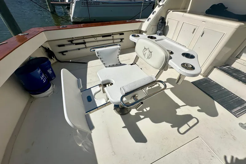  Yacht Photos Pics Fishing chair on 1989 Viking 48 yacht deck, featuring rod holders and cup holders.