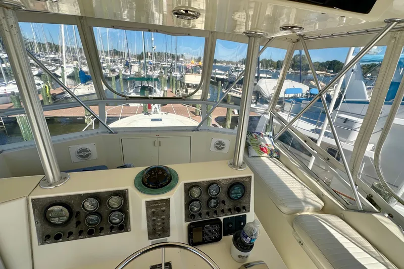  Yacht Photos Pics Helm of 1989 Viking 48 yacht with marina view, featuring gauges and seating.