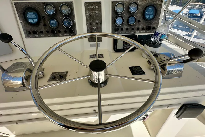  Yacht Photos Pics 1989 Viking 48 yacht helm with steering wheel, controls, and gauges.