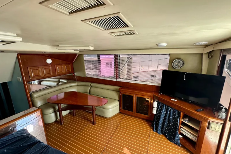  Yacht Photos Pics Interior of 1989 Viking 48 yacht with wood accents, seating, and TV.