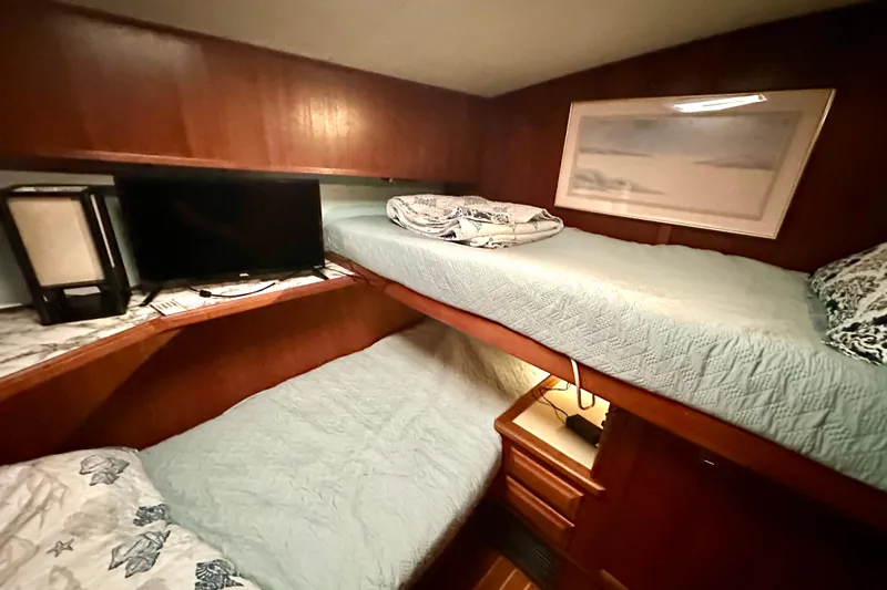  Yacht Photos Pics Cozy cabin interior of 1989 Viking 48 yacht with bunk beds and TV.