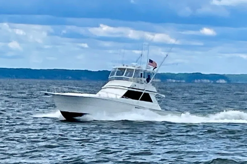  Yacht Photos Pics 1989 Viking 48 yacht cruising on open water under a cloudy sky.