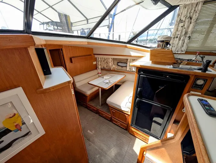 Infinity Bound Yacht Photos Pics Interior of 1991 Carver 430 Cockpit Motor Yacht with seating, table, and kitchenette.