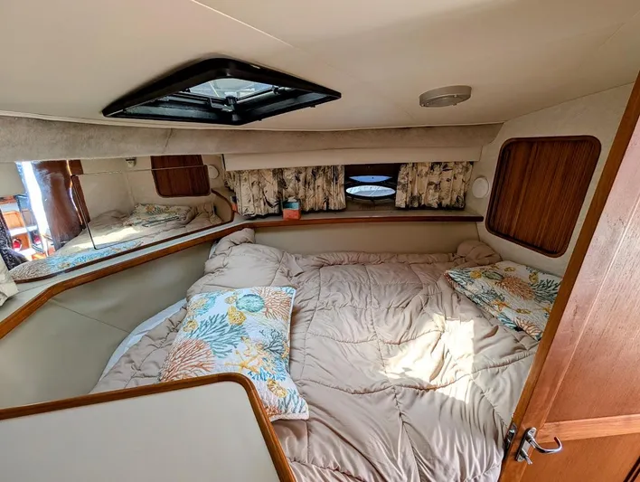 Infinity Bound Yacht Photos Pics Cozy bedroom interior of 1991 Carver 430 Cockpit Motor Yacht with floral bedding.