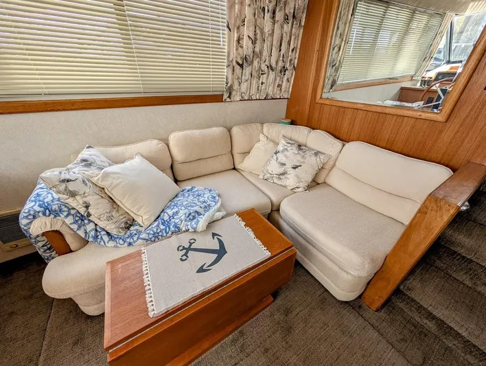 Infinity Bound Yacht Photos Pics Cozy interior of 1991 Carver 430 Cockpit Motor Yacht with plush seating and nautical decor.