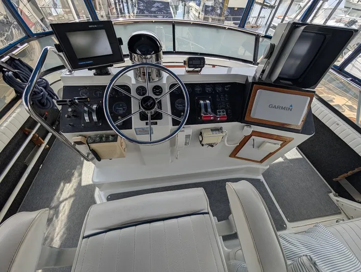 Infinity Bound Yacht Photos Pics 1991 Carver 430 Cockpit Motor Yacht helm with Garmin navigation and control instruments.