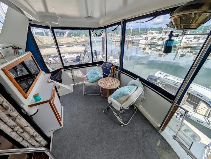 Infinity Bound Yacht Photos Pics 1991 Carver 430 Cockpit Motor Yacht interior with seating and marina view.