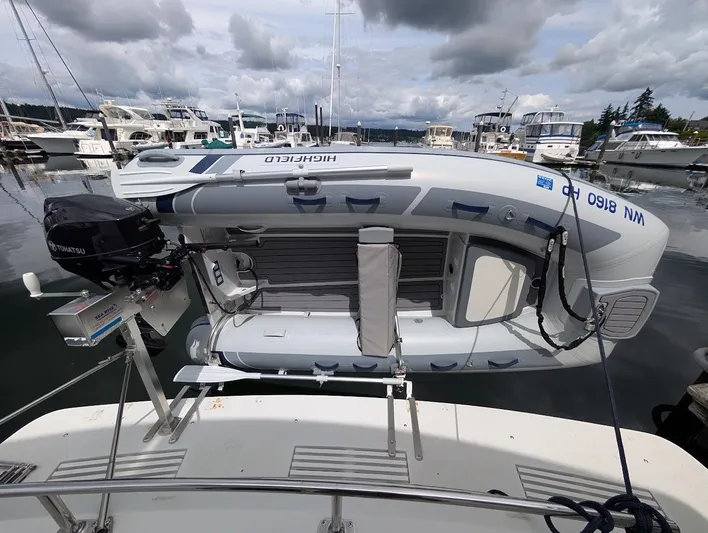 Infinity Bound Yacht Photos Pics Inflatable boat on Carver 430 Cockpit Motor Yacht, 1991, docked at marina under cloudy sky.