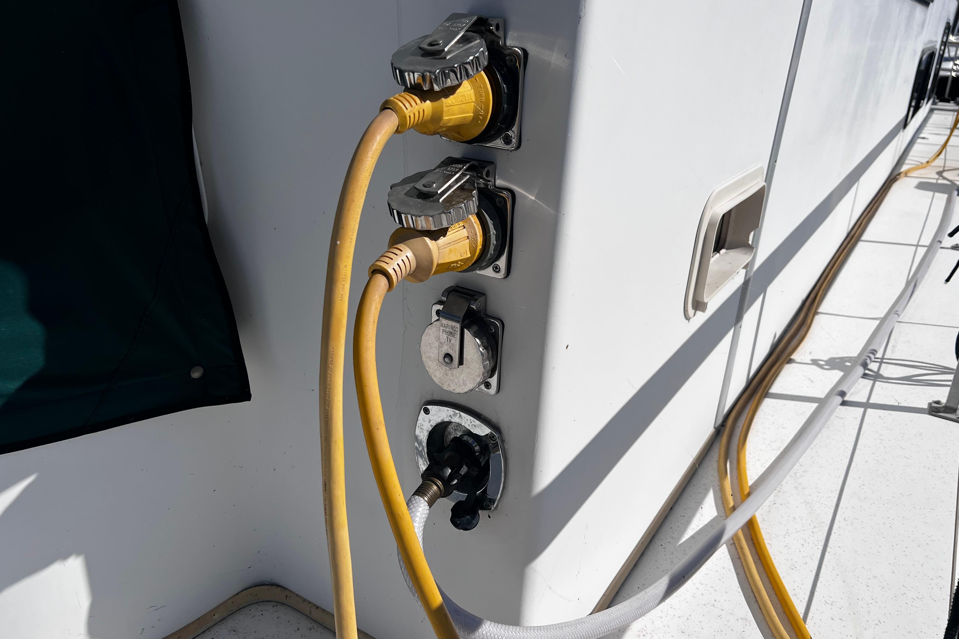 Electrical connections on a 1994 Gibson 44 Classic boat with yellow power cables.