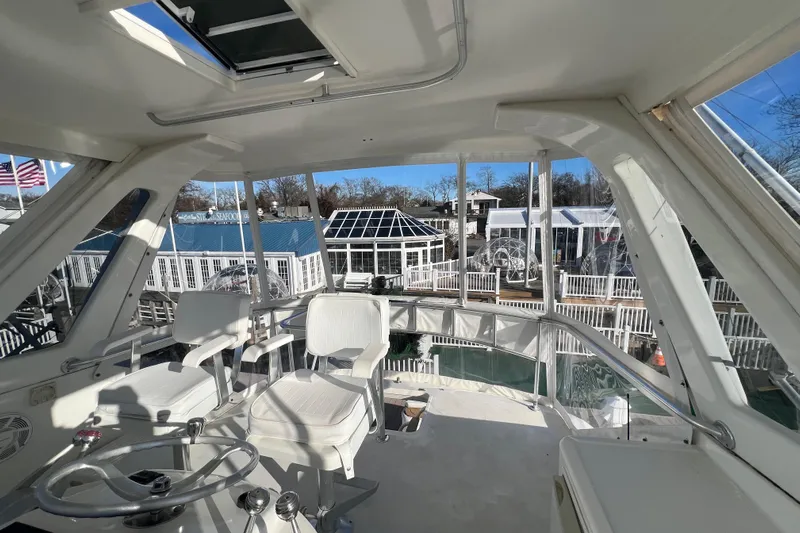 The Oar Deal Yacht Photos Pics Interior view of 1999 Ocean Yachts 56 Super Sport, featuring helm and seating area.