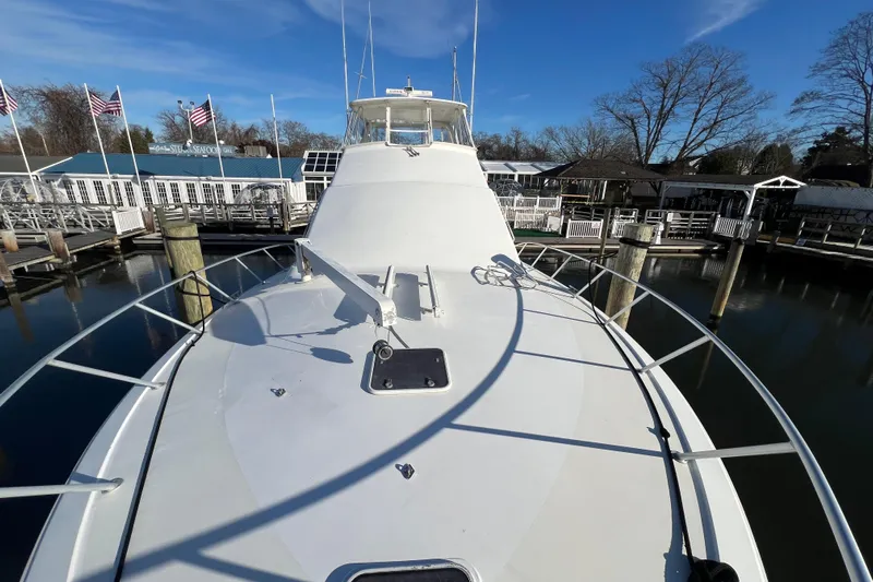 The Oar Deal Yacht Photos Pics 1999 Ocean Yachts 56 Super Sport docked at marina under clear blue sky.