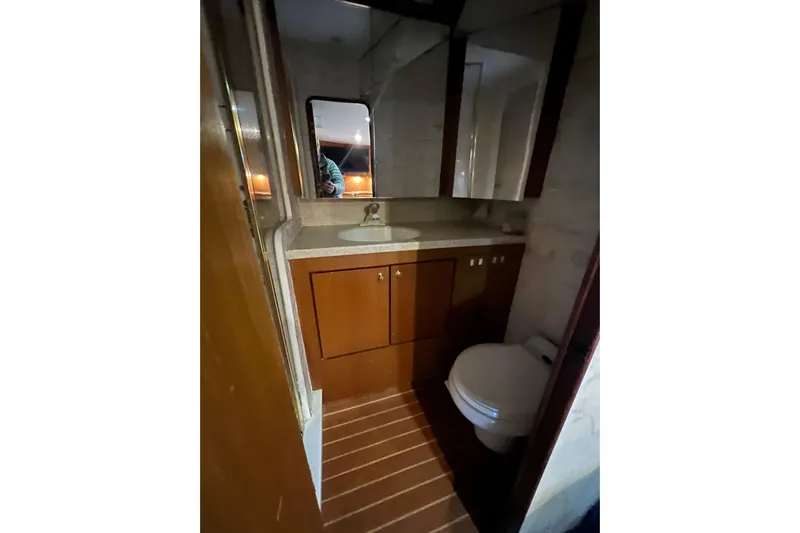 The Oar Deal Yacht Photos Pics Bathroom interior of 1999 Ocean Yachts 56 Super Sport with wooden cabinetry.
