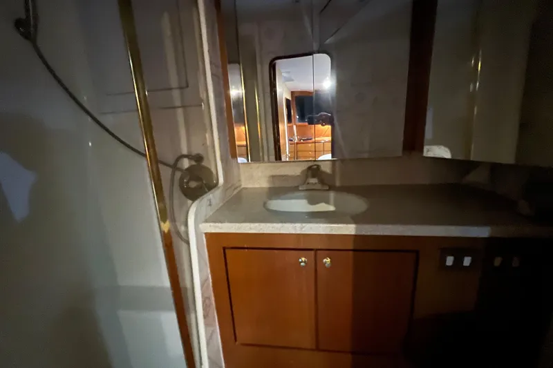 The Oar Deal Yacht Photos Pics Bathroom interior of 1999 Ocean Yachts 56 Super Sport, featuring sink and shower.