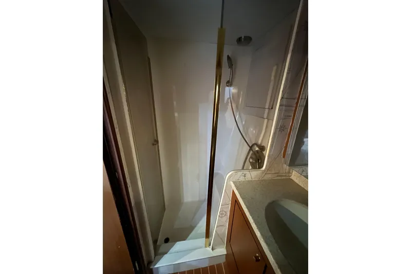 The Oar Deal Yacht Photos Pics Shower area in 1999 Ocean Yachts 56 Super Sport, featuring sleek design and modern fixtures.