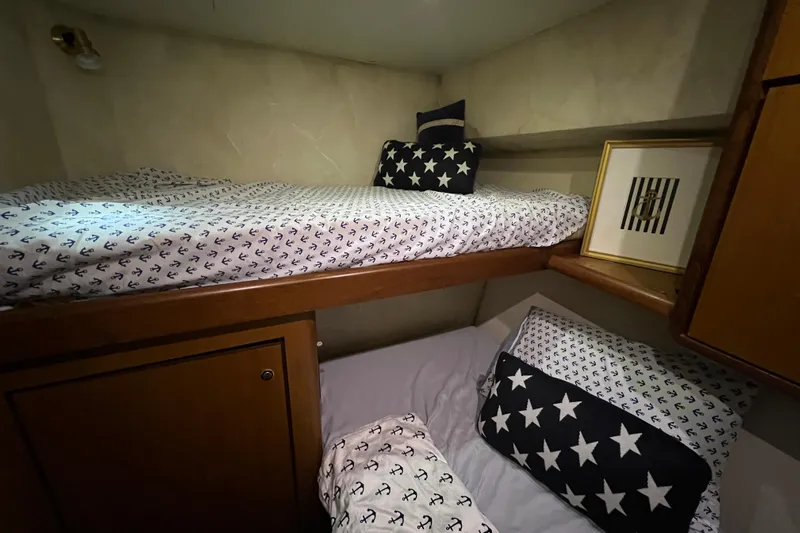 The Oar Deal Yacht Photos Pics Bunk beds with nautical-themed bedding in 1999 Ocean Yachts 56 Super Sport cabin.