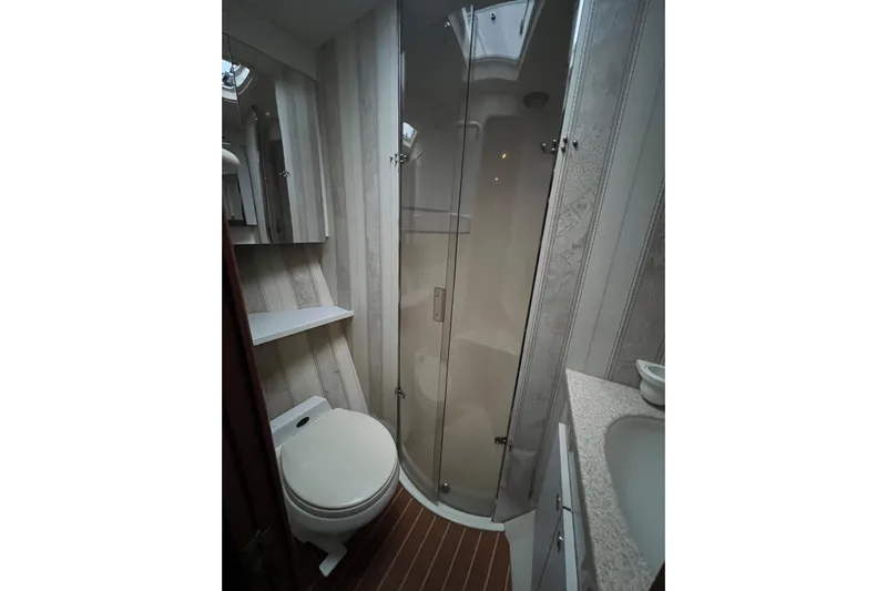 The Oar Deal Yacht Photos Pics Bathroom interior of 1999 Ocean Yachts 56 Super Sport with shower and toilet.
