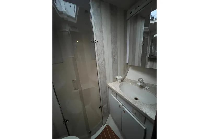 The Oar Deal Yacht Photos Pics Bathroom interior of 1999 Ocean Yachts 56 Super Sport with shower and sink.