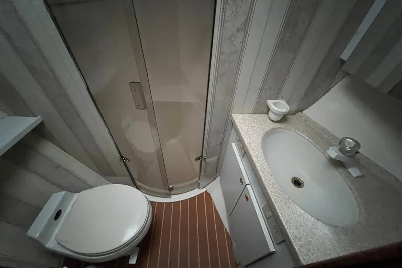The Oar Deal Yacht Photos Pics Bathroom interior of 1999 Ocean Yachts 56 Super Sport with shower, toilet, and sink.