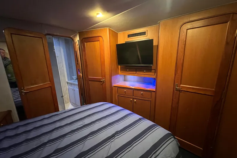 The Oar Deal Yacht Photos Pics Luxurious cabin interior of 1999 Ocean Yachts 56 Super Sport with wood paneling and TV.
