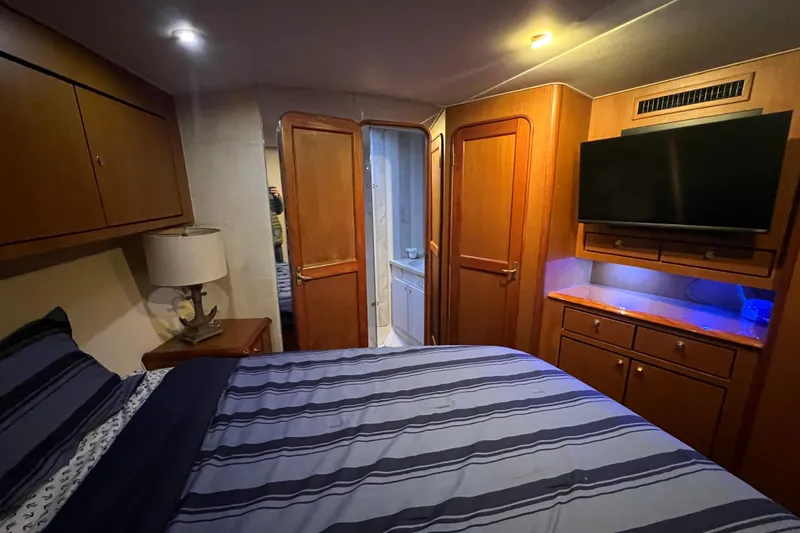 The Oar Deal Yacht Photos Pics Luxurious cabin interior of 1999 Ocean Yachts 56 Super Sport with wood finishes and modern amenities.