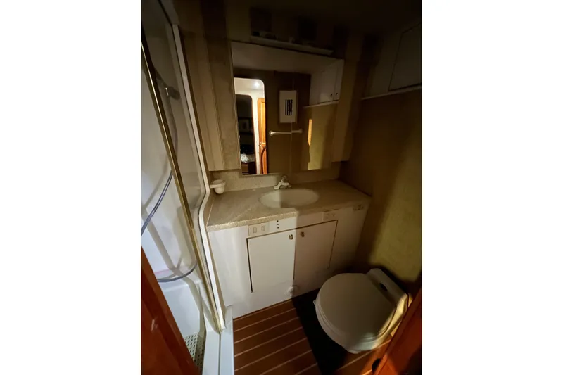The Oar Deal Yacht Photos Pics Bathroom interior of 1999 Ocean Yachts 56 Super Sport, featuring sink and toilet.