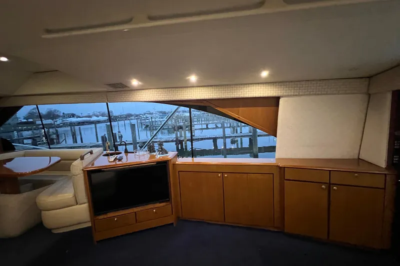 The Oar Deal Yacht Photos Pics Interior of 1999 Ocean Yachts 56 Super Sport with waterfront view and wooden cabinetry.