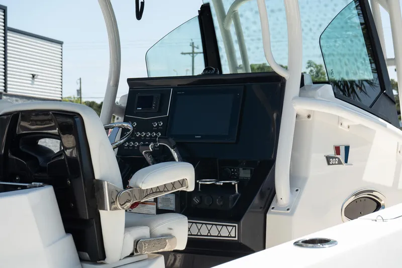  Yacht Photos Pics 2018 Wellcraft 302 Fisherman boat cockpit with modern controls and seating.