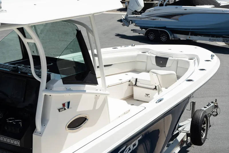  Yacht Photos Pics 2018 Wellcraft 302 Fisherman boat on trailer, featuring spacious seating and modern design.