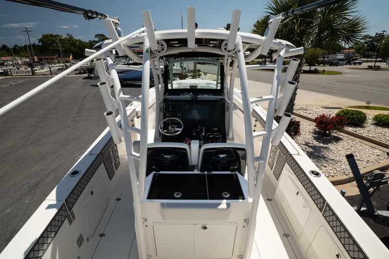  Yacht Photos Pics 2018 Wellcraft 302 Fisherman boat with center console and rod holders, parked outdoors.