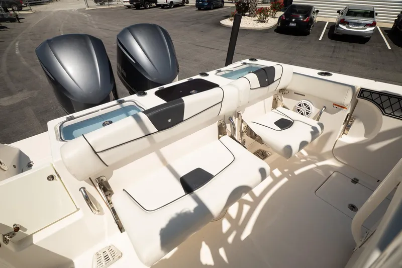  Yacht Photos Pics 2018 Wellcraft 302 Fisherman boat interior with seating and dual outboard engines.