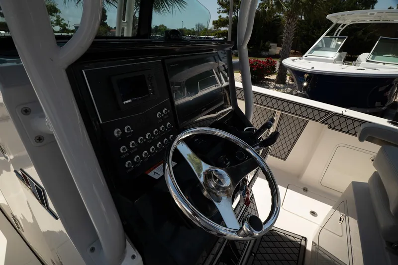  Yacht Photos Pics 2018 Wellcraft 302 Fisherman boat dashboard with steering wheel and control panel.