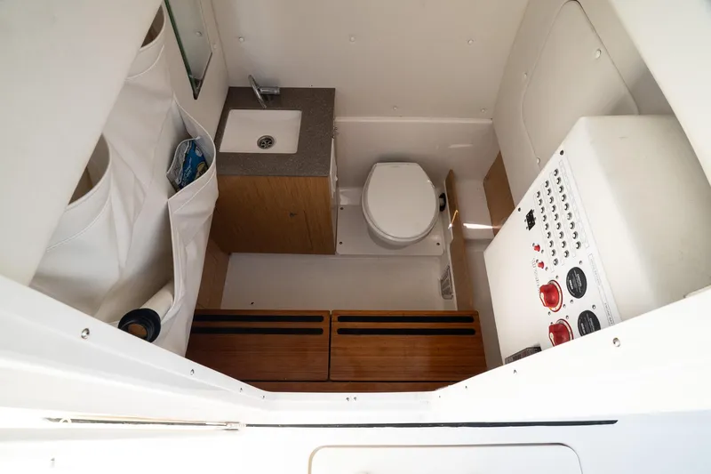  Yacht Photos Pics 2018 Wellcraft 302 Fisherman boat interior with sink, toilet, and control panel.