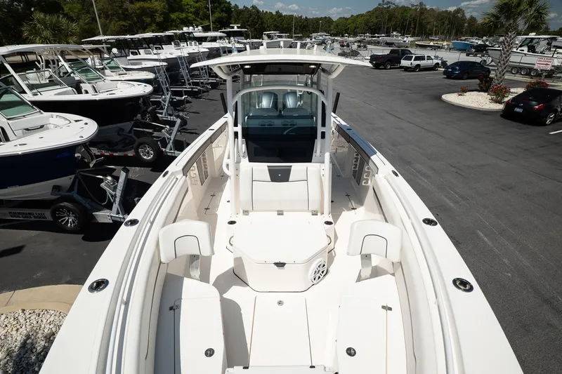  Yacht Photos Pics 2018 Wellcraft 302 Fisherman boat in a marina, showcasing spacious deck and seating.