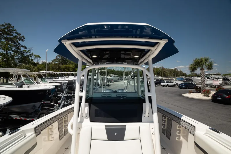  Yacht Photos Pics 2018 Wellcraft 302 Fisherman boat with T-top, docked in a marina under clear skies.