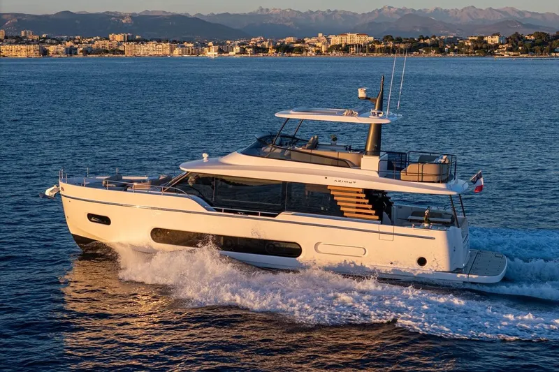  Yacht Photos Pics 2025 Azimut Magellano 60 yacht cruising on the ocean at sunset.