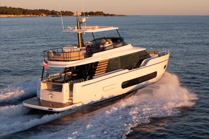  Yacht Photos Pics 2025 Azimut Magellano 60 yacht cruising on open water at sunset.