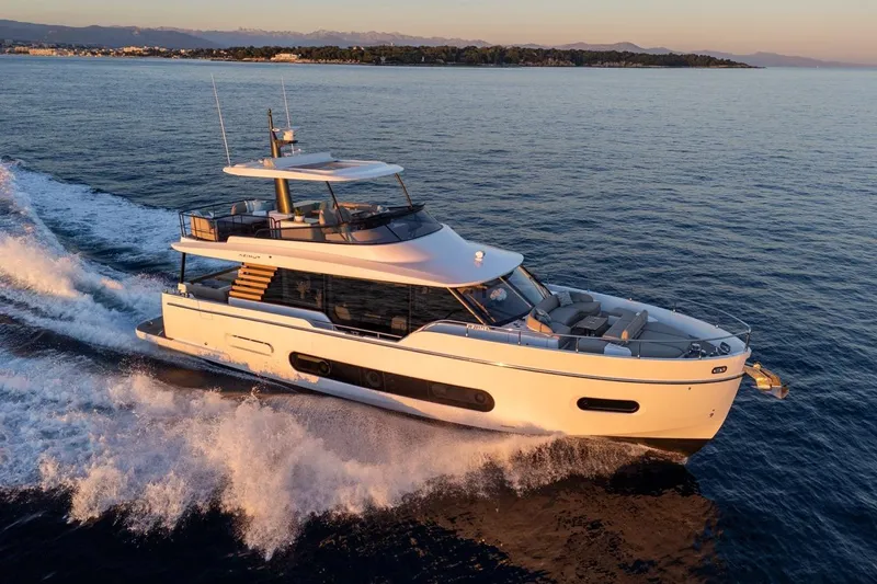  Yacht Photos Pics 2025 Azimut Magellano 60 yacht cruising on open water at sunset.