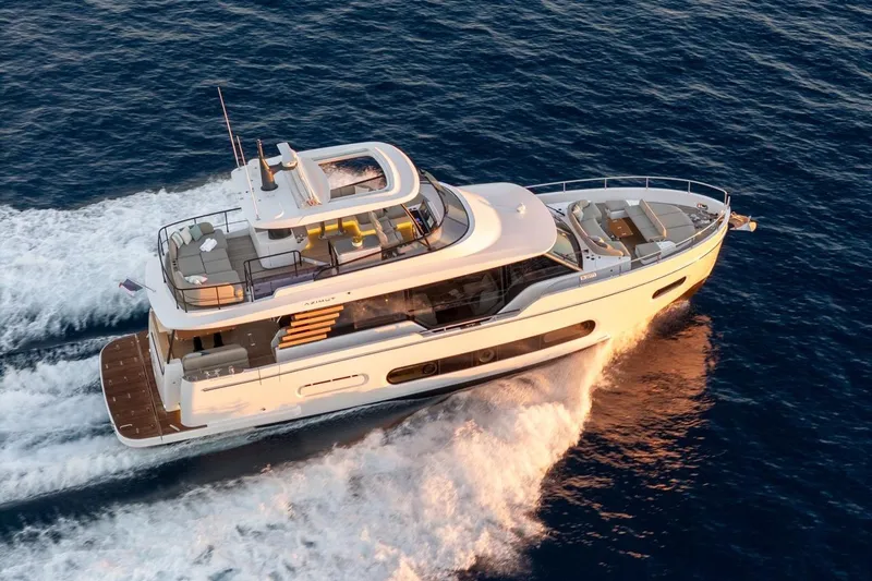 Yacht Photos Pics 2025 Azimut Magellano 60 yacht cruising on open sea, showcasing luxury design.