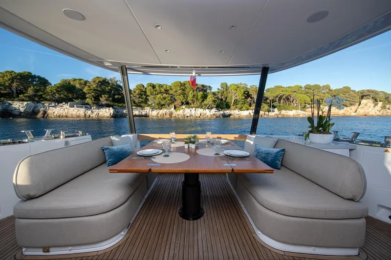  Yacht Photos Pics Luxurious dining area on 2025 Azimut Magellano 60 yacht with scenic ocean view.