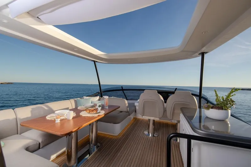  Yacht Photos Pics Luxurious 2025 Azimut Magellano 60 yacht interior with ocean view and elegant dining setup.