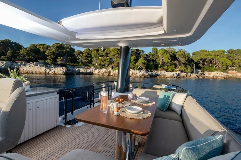  Yacht Photos Pics Azimut Magellano 60 Yacht 2025, luxurious outdoor seating with table and cushions.