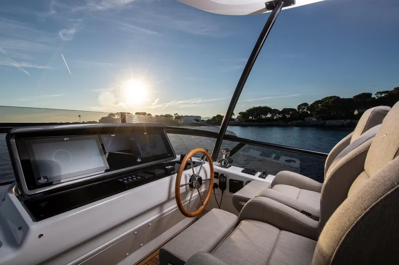  Yacht Photos Pics Cockpit view of 2025 Azimut Magellano 60 yacht at sunset, featuring modern navigation displays.