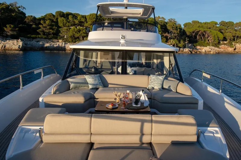  Yacht Photos Pics Luxurious 2025 Azimut Magellano 60 yacht with elegant outdoor seating and scenic ocean backdrop.